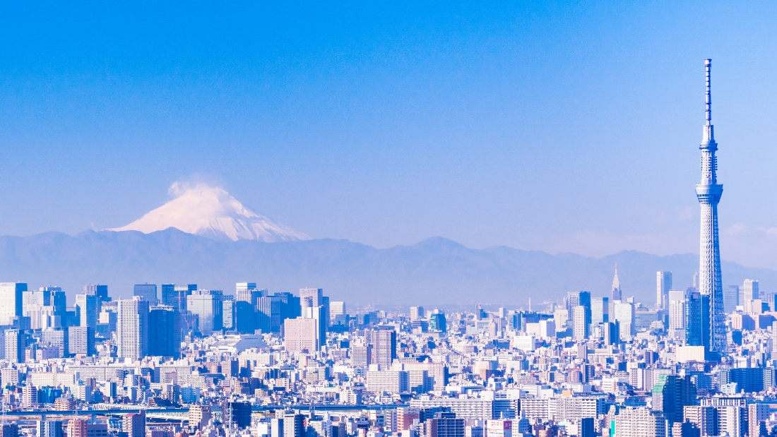 A panoramic view of a city skyline under a clear blue sky.