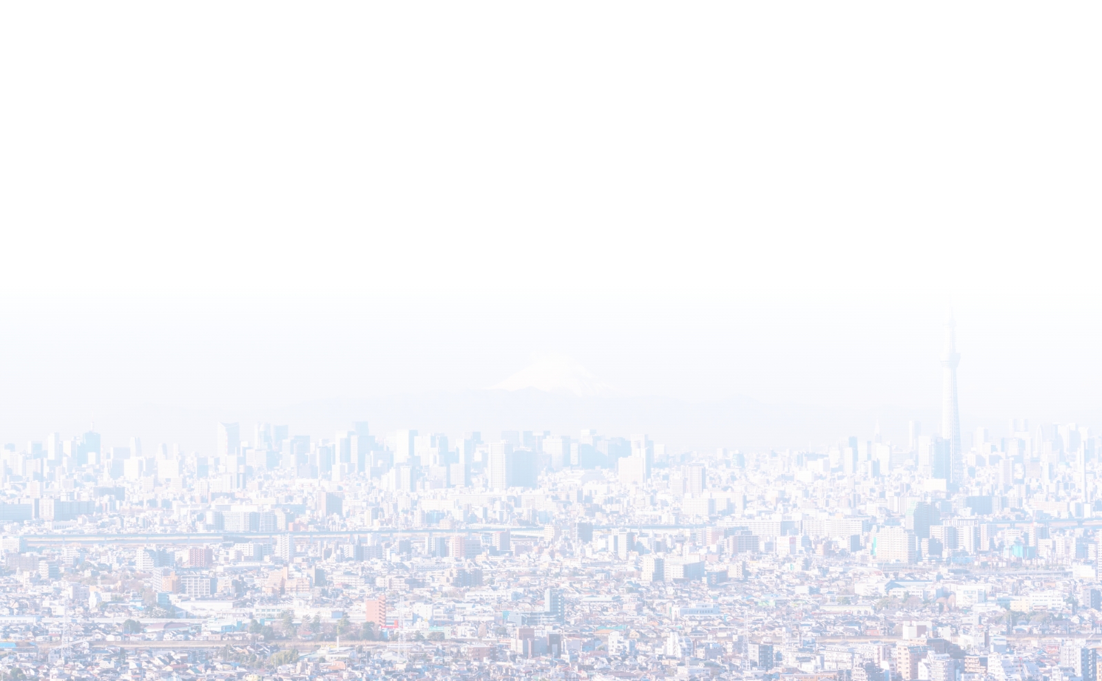 A panoramic view of a city skyline under a clear blue sky.